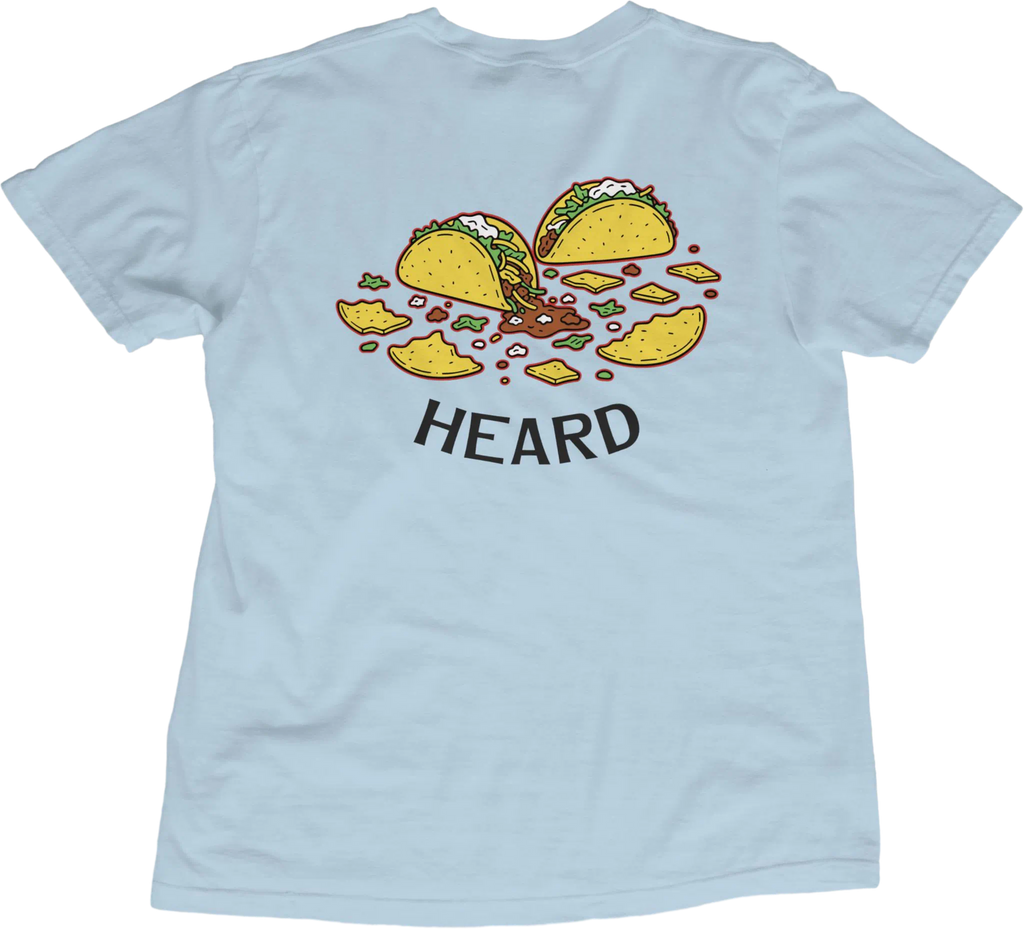 Light blue t-shirt with taco graphic and 'HEARD' text on a white background